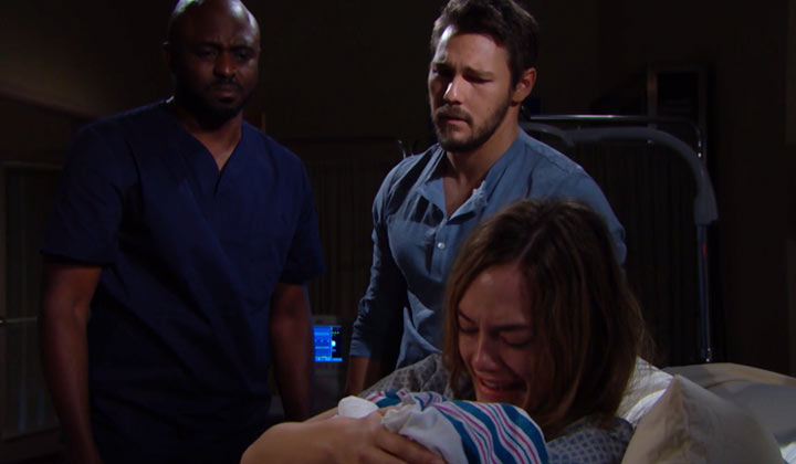 Hope cradles her dead baby while Liam and Reese look on